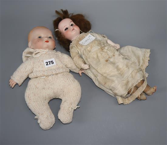 An A.M. open mouthed bisque headed doll and a baby doll